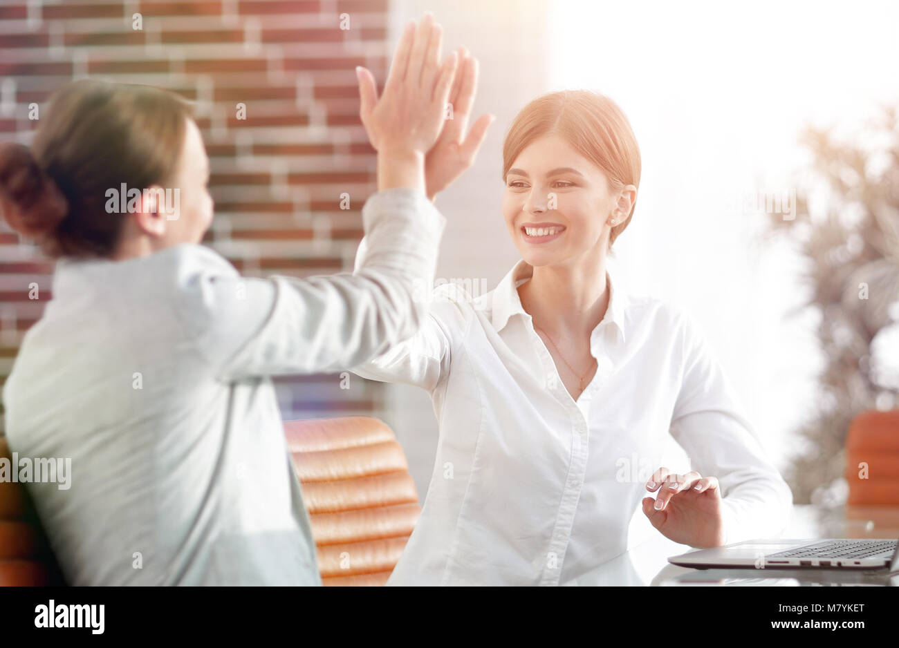 members of the business team giving each other a high five Stock Photo ...