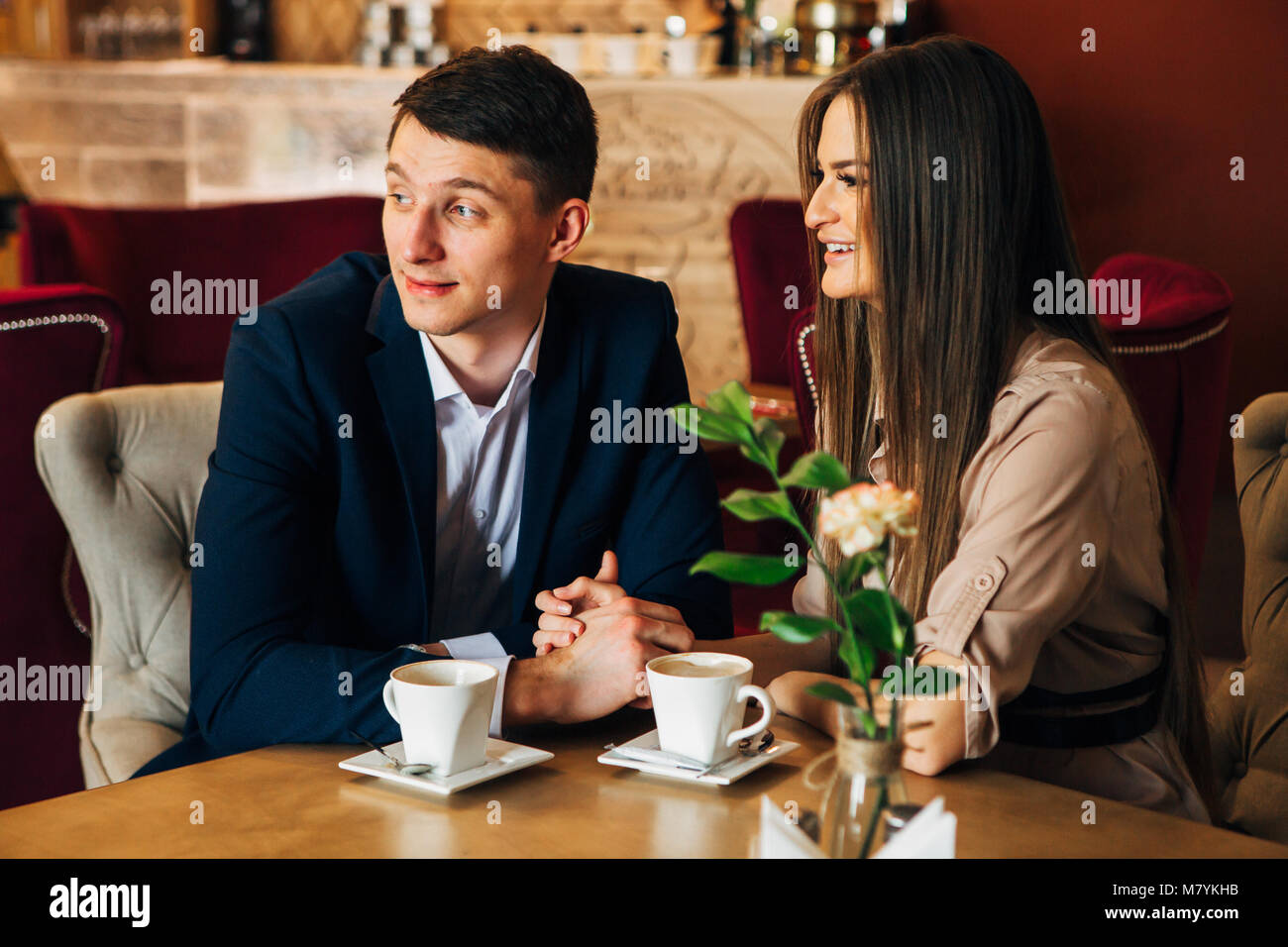 Happy young couple taking selfie with smart phone at cafe Stock Photo