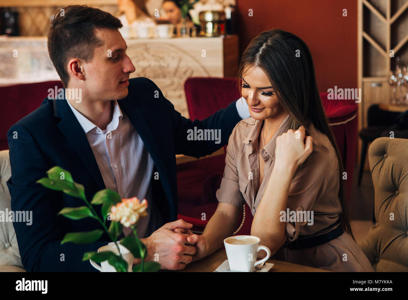 Happy young couple taking selfie with smart phone at cafe Stock Photo