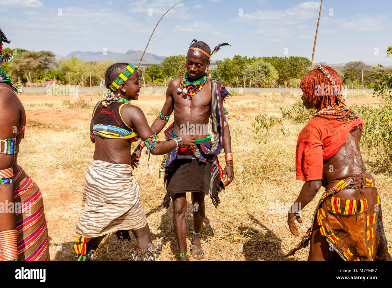 A Hamar Tribesman Whipping Young Hamar Women. The Young Women Ask