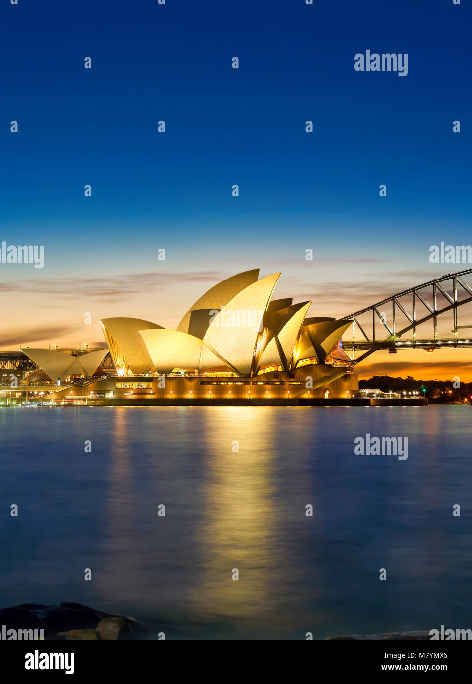 Sydney Opera House with Sydney Harbor Bridge, Sydney Harbour Bridge at sunset Sydney Australia New South Wales. Stock Photo