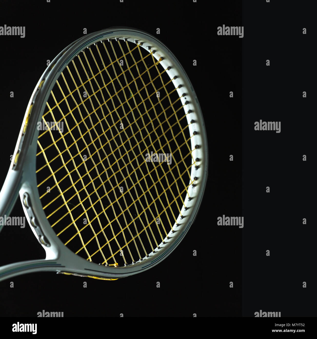 Tennis racket on black background Stock Photo - Alamy