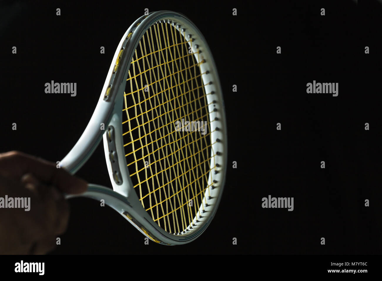 Tennis racket on black background Stock Photo - Alamy