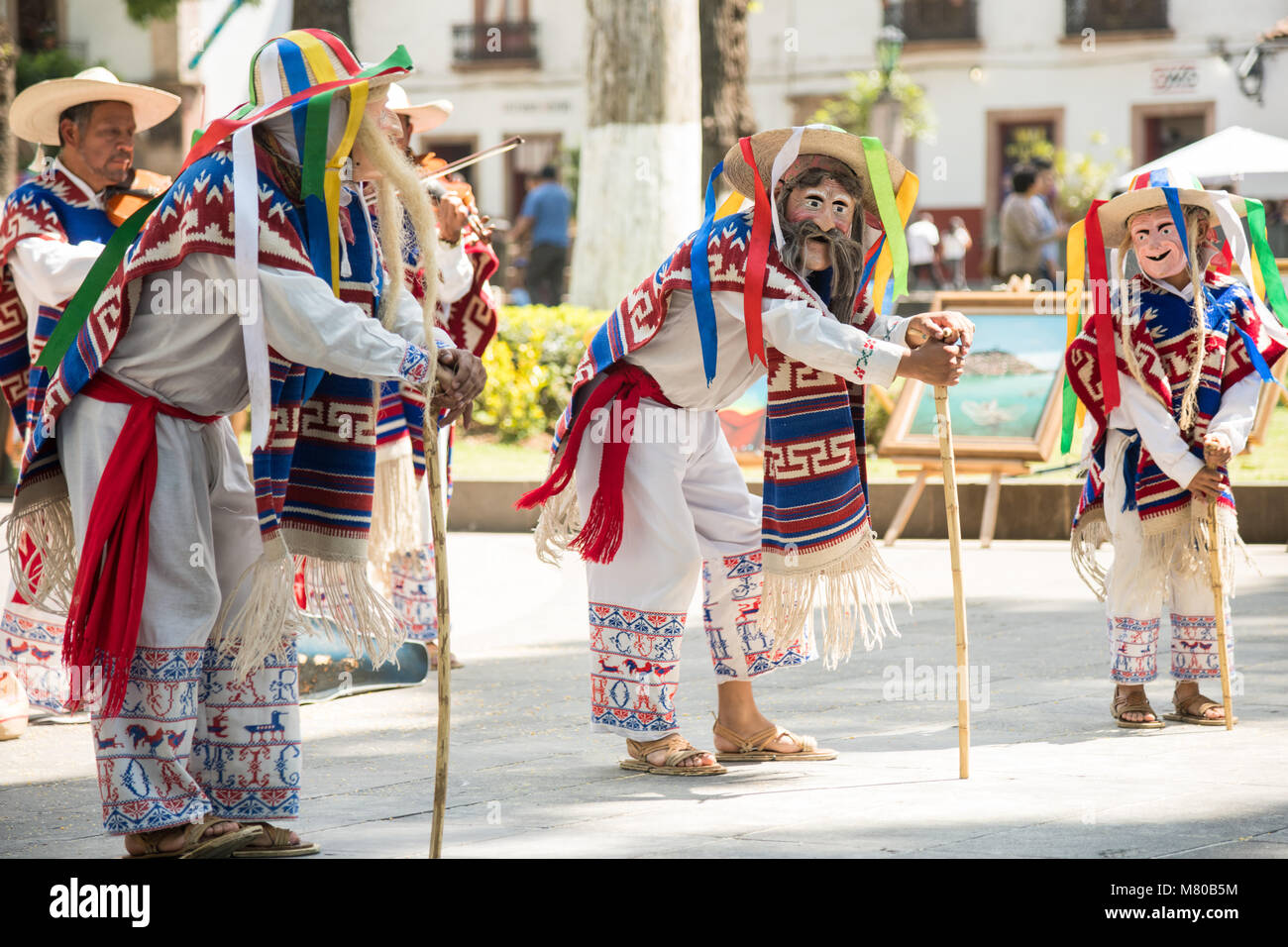 Costumed as old men traditional dancers perform the La Danza de los ...