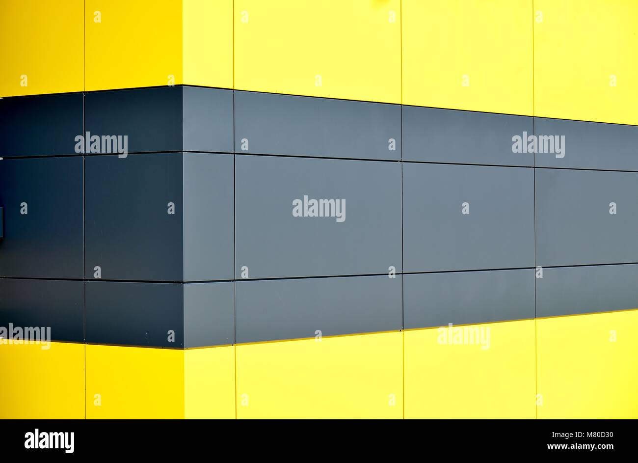 Perspective abstract background of yellow and gray aluminium cladding on the exterior of a modern warehouse Stock Photo