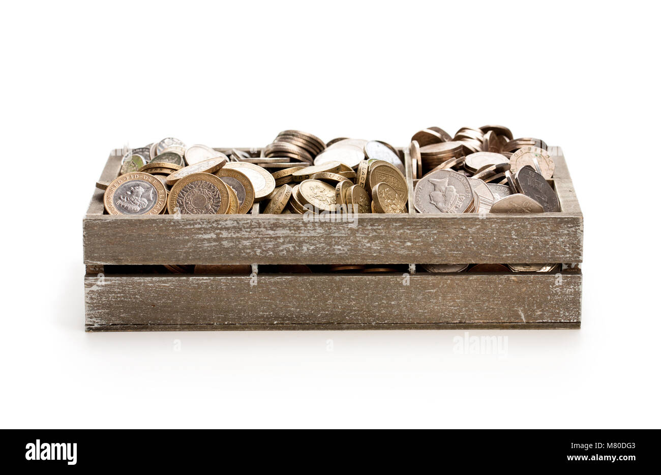 wooden  cashbox full of pound sterling coins Stock Photo