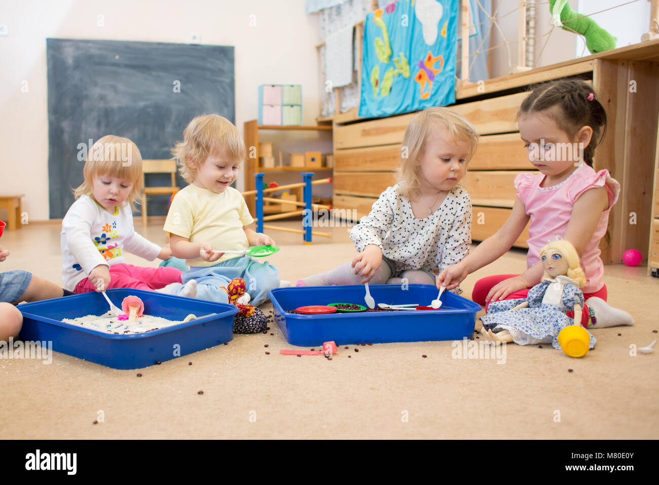Group of children playing in kindergarten or daycare centre Stock Photo