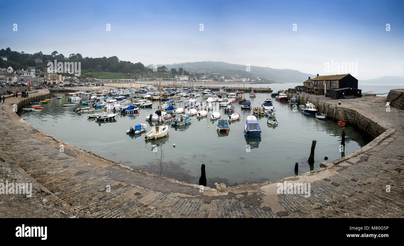 Panorama landscape of traditional fishing harbour at Lyme Regis in England Stock Photo