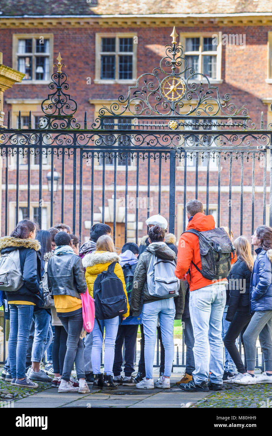 A group of school students (on a guided tour) outside the main gate at St Catherine's college, Cambridge University, on a sunny winter day. Stock Photo