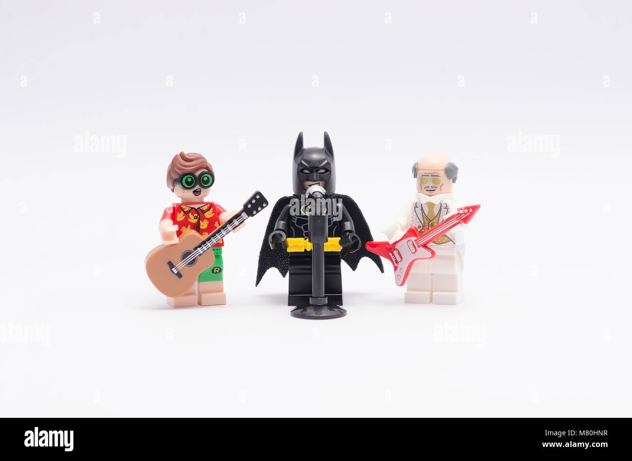 lego batman singing with alfred and robin play the guitar. isolated on  white background Stock Photo - Alamy