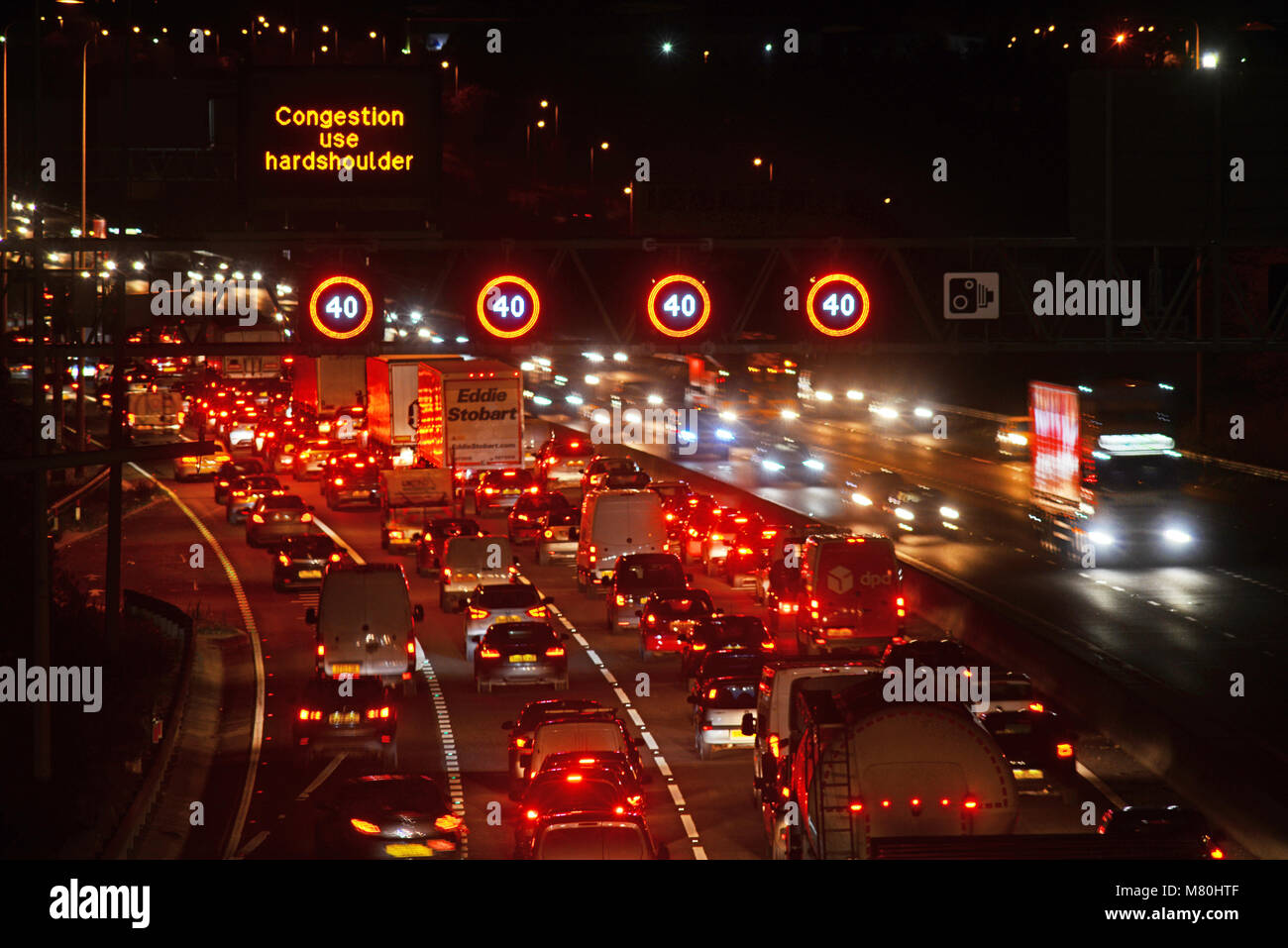 traffic jam by reduced speed limit and speed camera warning signs and