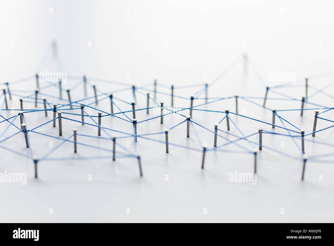 A large grid of pins connected with string. Communication, technology ...