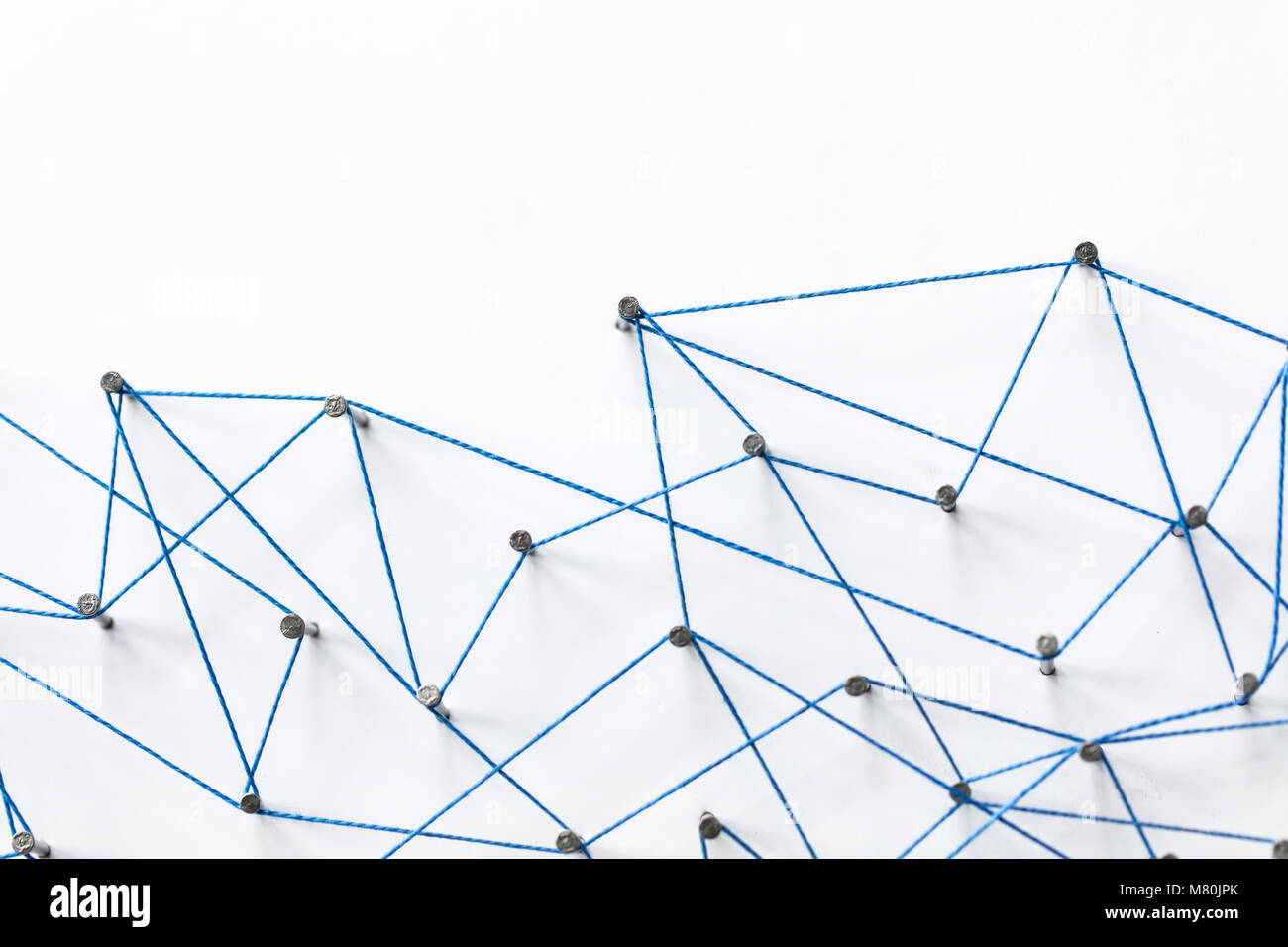 A large grid of pins connected with string. Communication, technology ...
