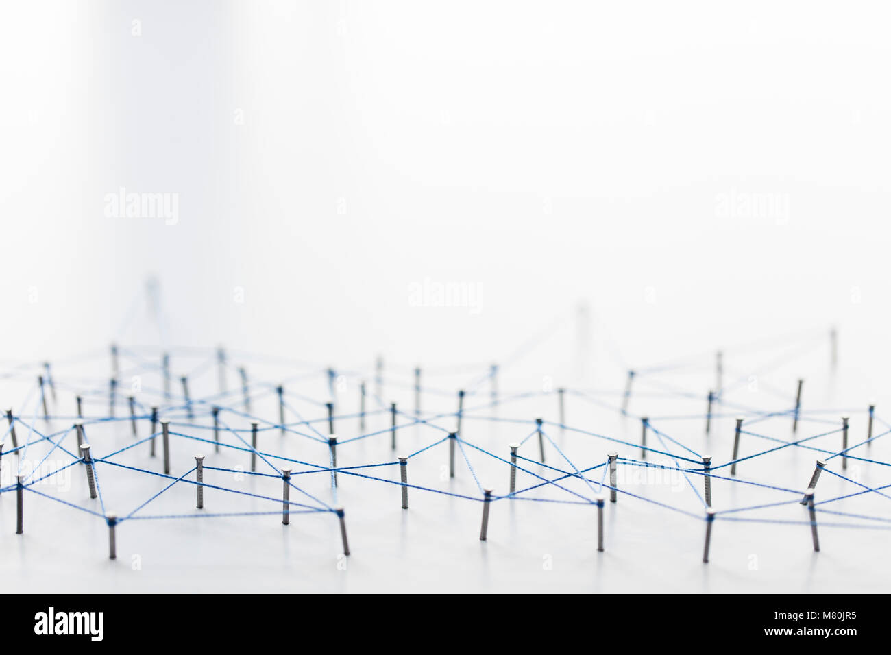 A large grid of pins connected with string. Communication, technology ...