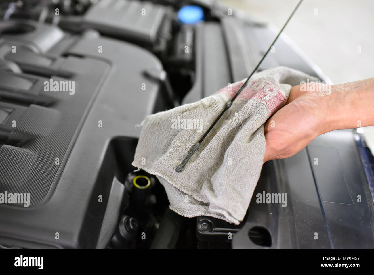 oil level control of the car engine by mechanics in a car