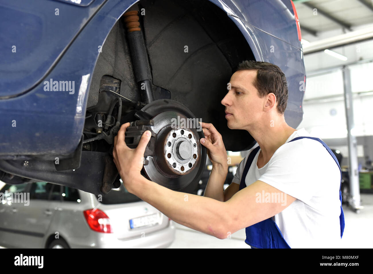 Garage with car repairs on a lift hi-res stock photography and images ...