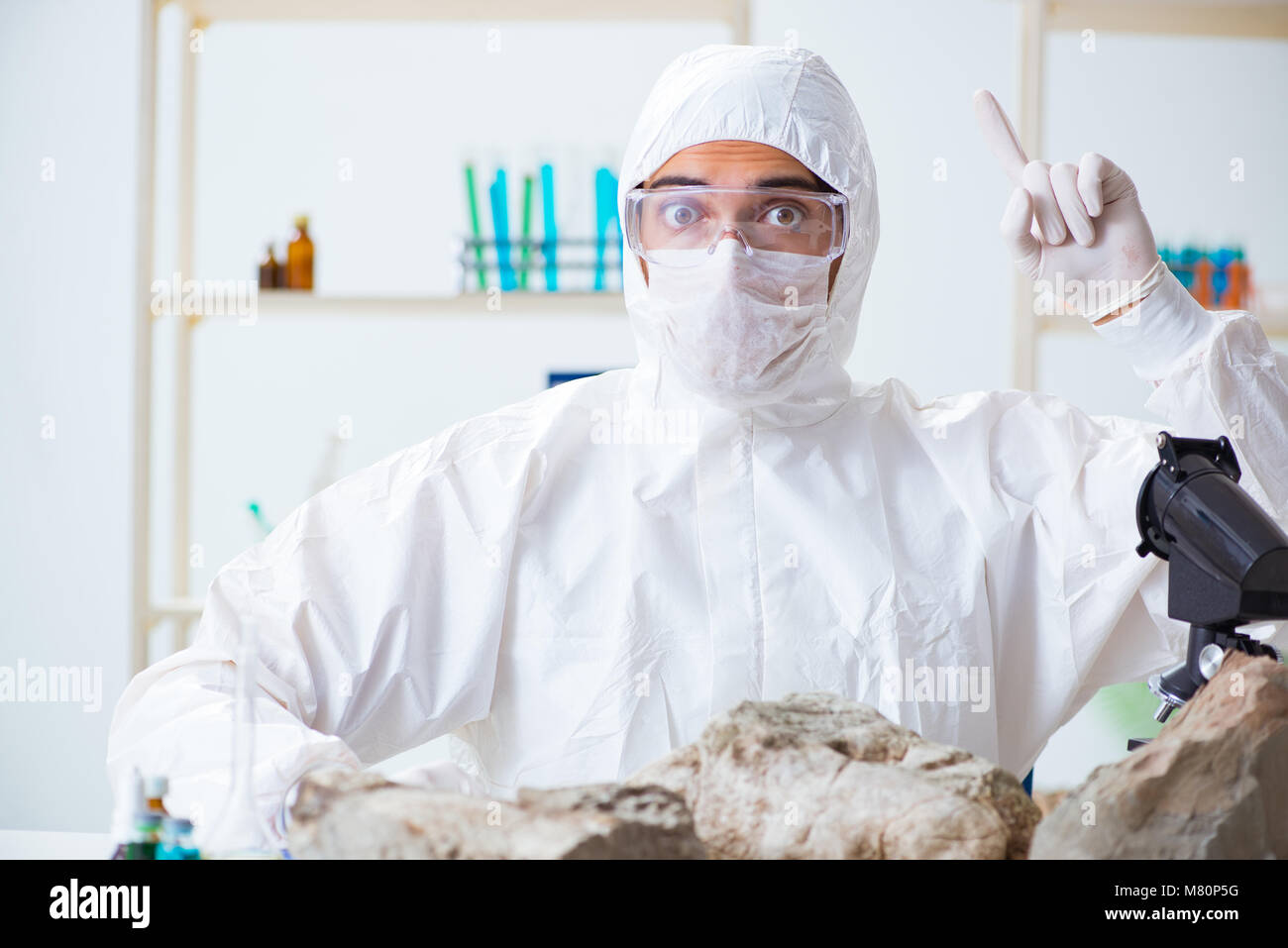Scientist looking and stone samples in lab Stock Photo - Alamy