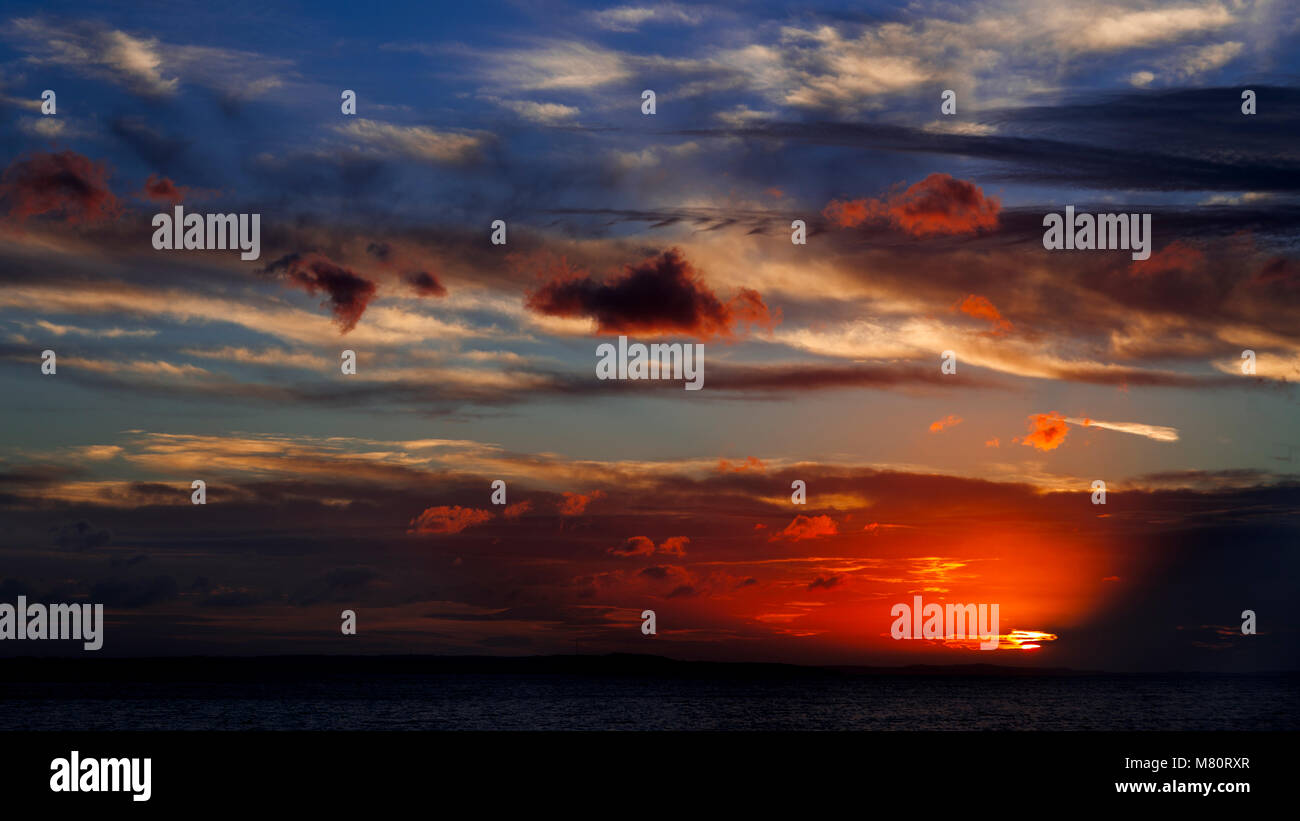 Lit clouds at sunset over the North Wales coast, Llandudno West Shore Stock Photo