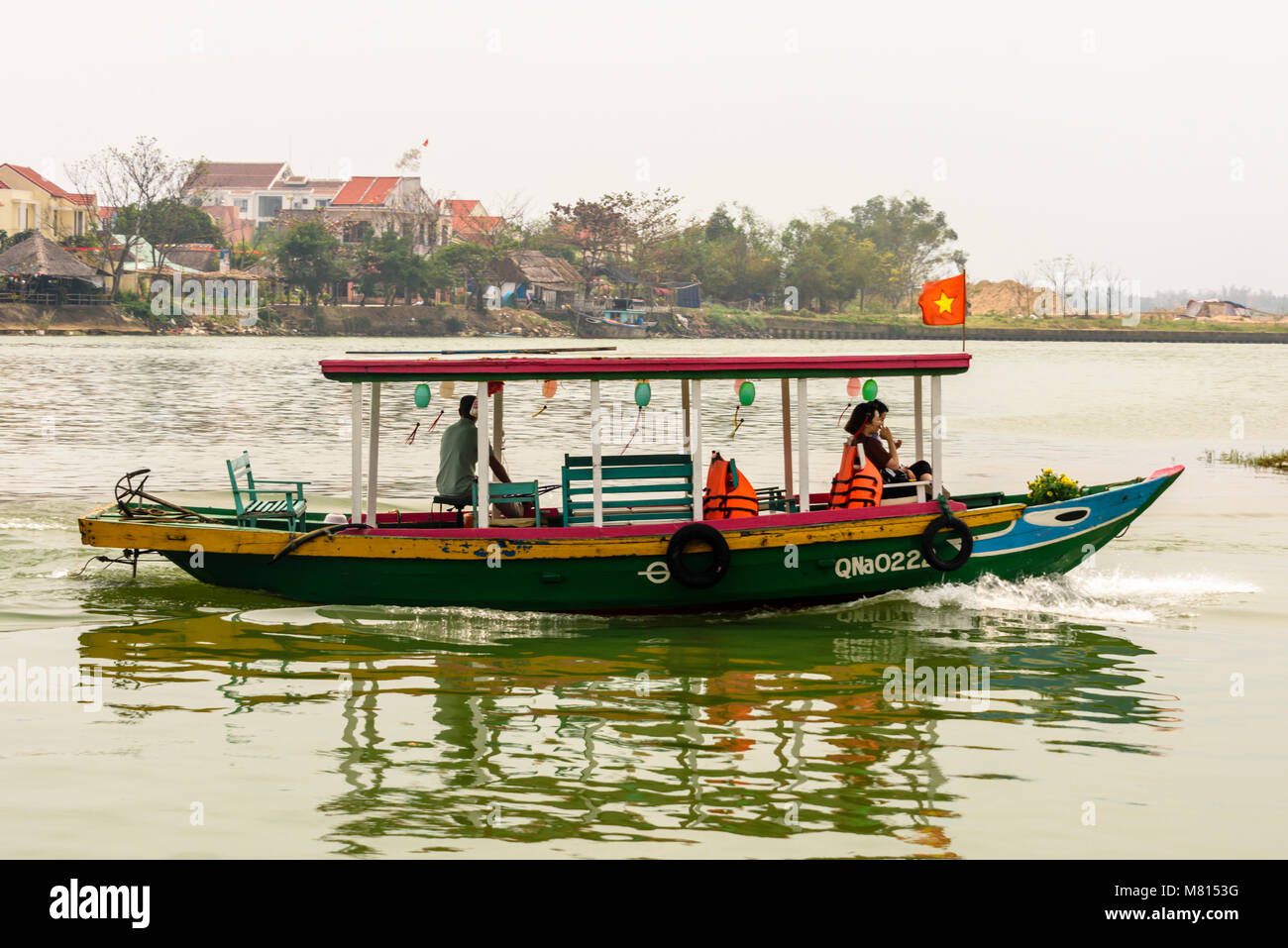 Tourist boats with Vietnamese flags at Hoi An, Vietnam Stock Photo