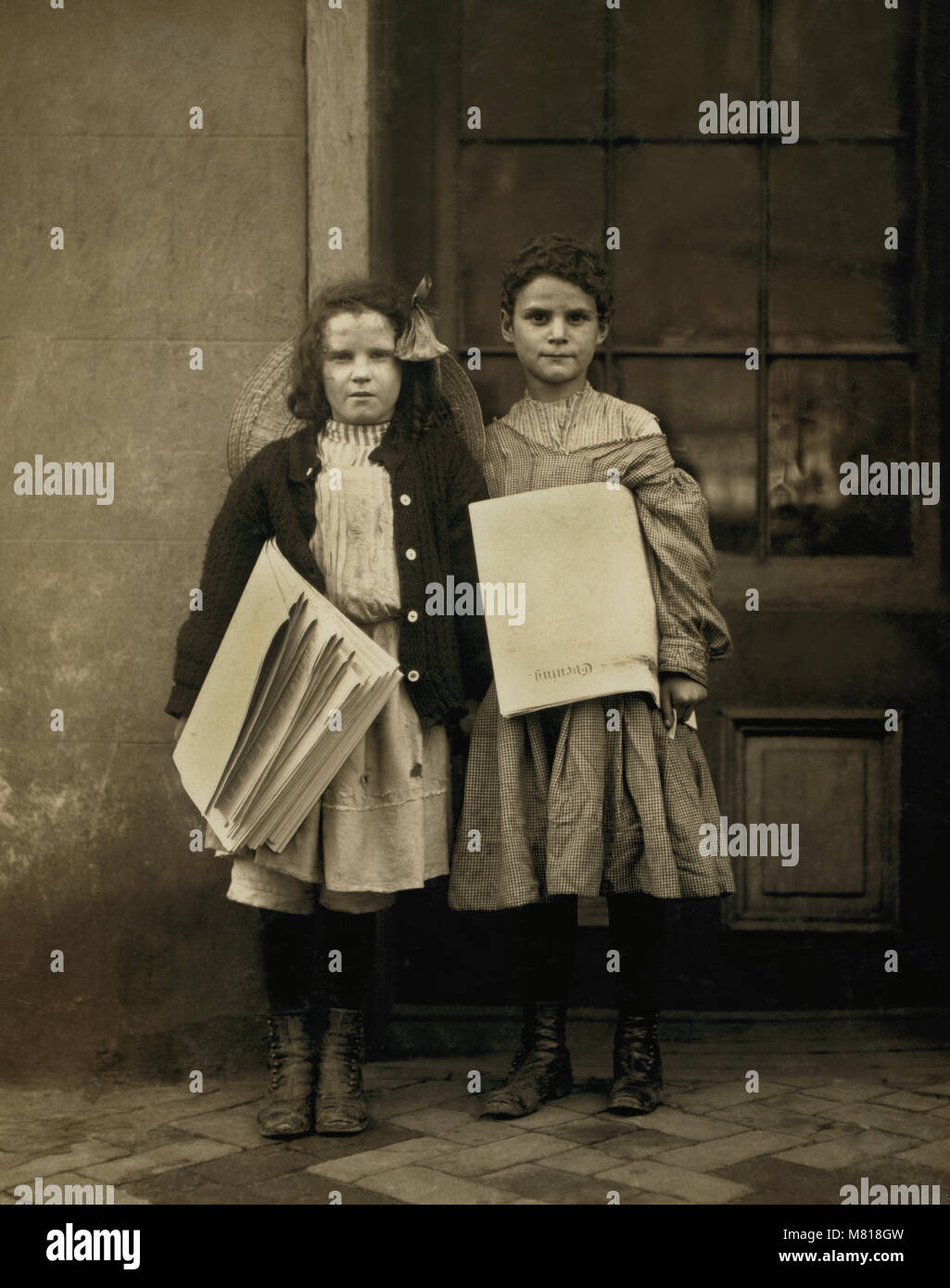 Two Young Girls Selling Newspapers, Full-Length Portrait, Wilmington, Delaware, USA, Lewis Hine for National Child Labor Committee, May 1910 Stock Photo