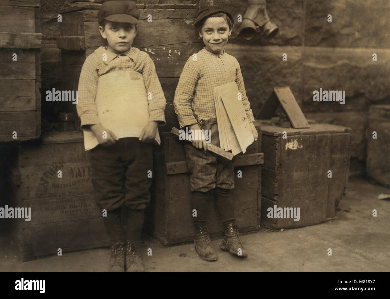 Two Young Newsboys, 7 and 9 years old, Full-Length Portrait Selling Newspapers, New Orleans, Louisiana, USA, Lewis Hine for National Child Labor Committee, November 1913 Stock Photo