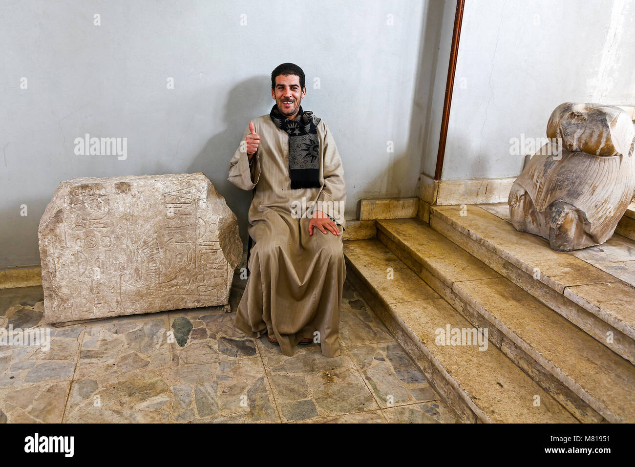 A guide giving a thumbs up sign at the open air museum at the UNESCO site at Memphis, Mit Rahinah, Al Badrashin, Egypt, Africa Stock Photo