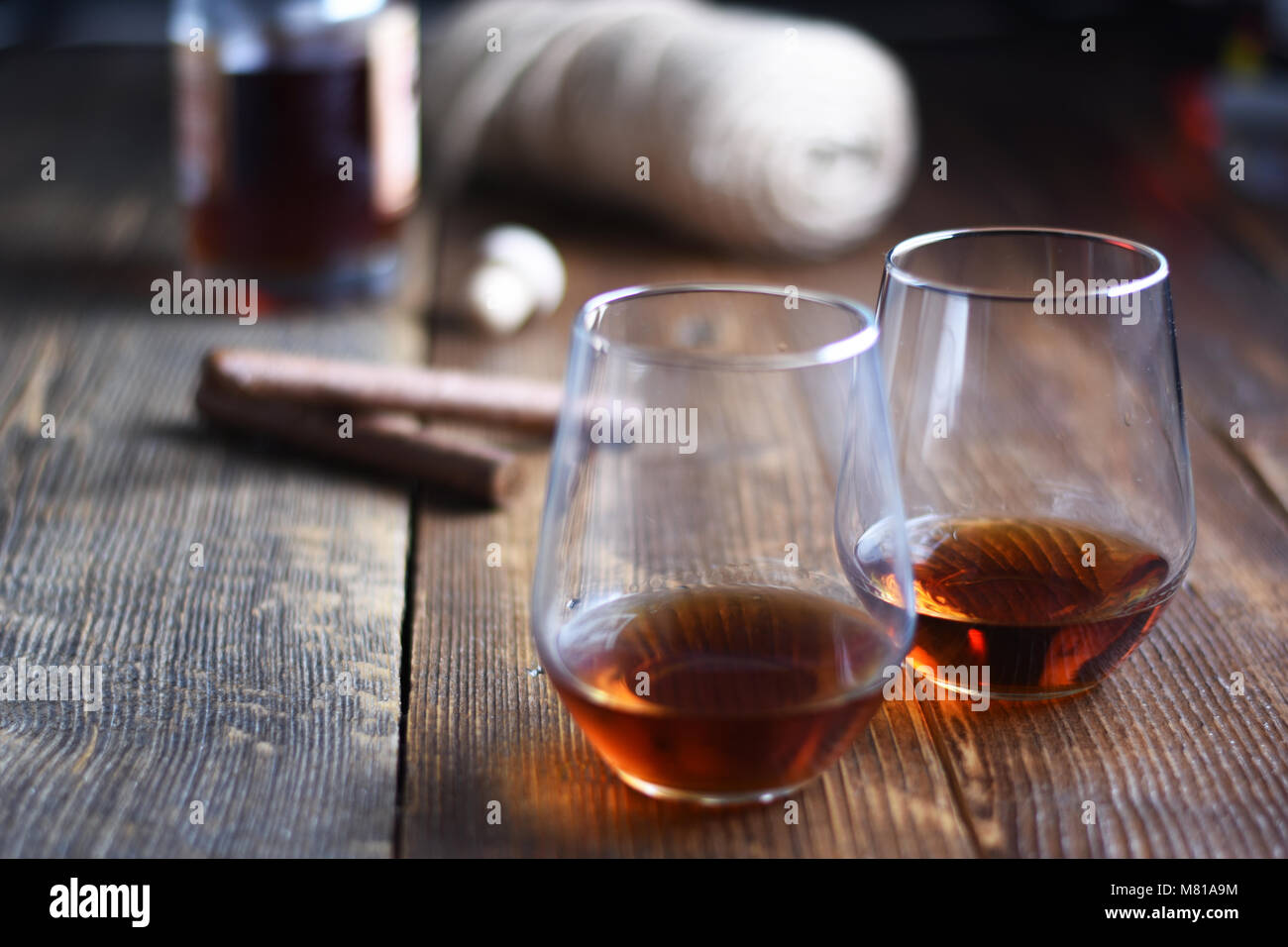 Vintage tools of Glass of rum on a rustic wooden table with cigars and bottle.barber shop on wooden background Stock Photo