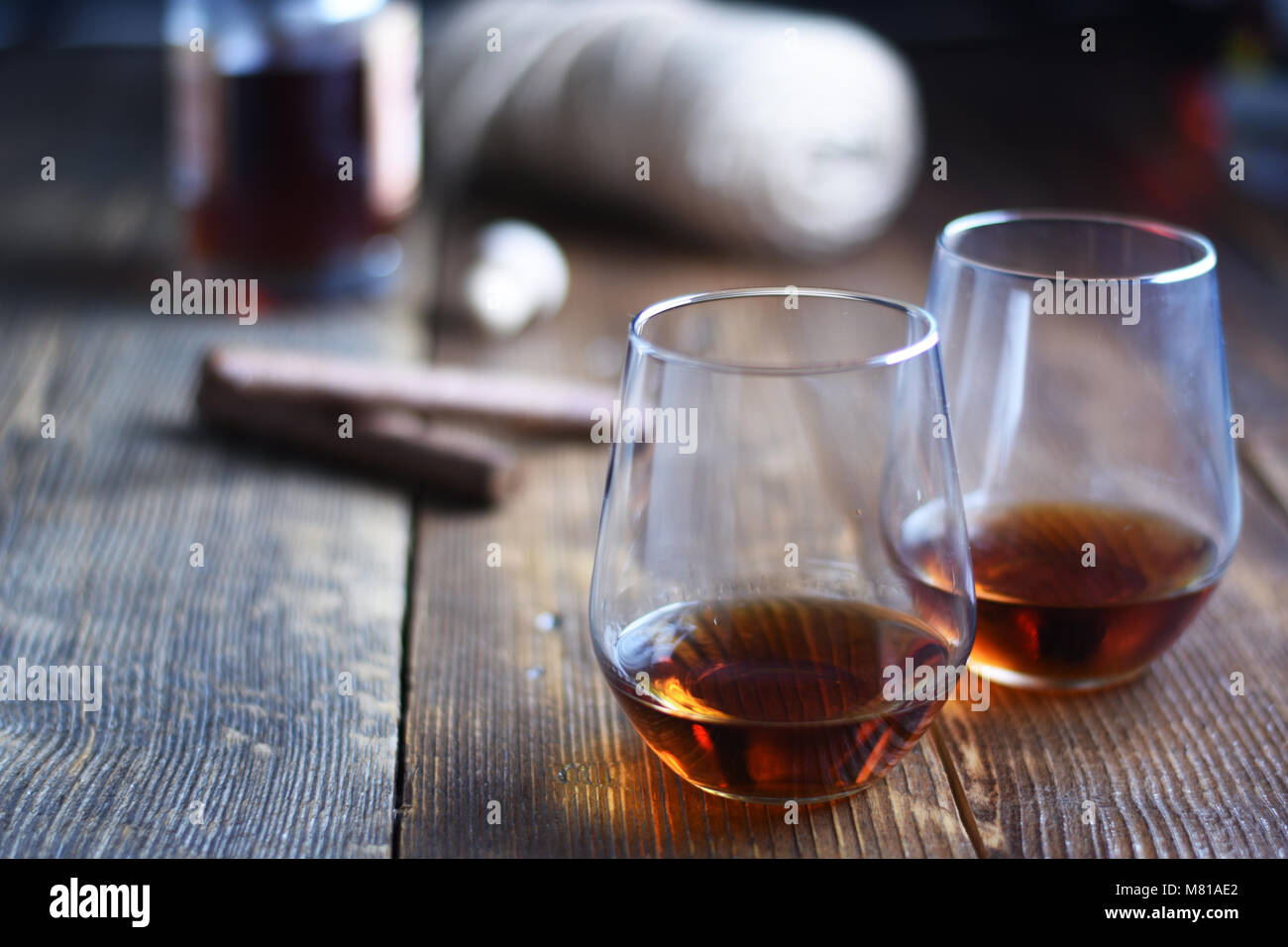 Vintage tools of Glass of rum on a rustic wooden table with cigars and bottle.barber shop on wooden background Stock Photo