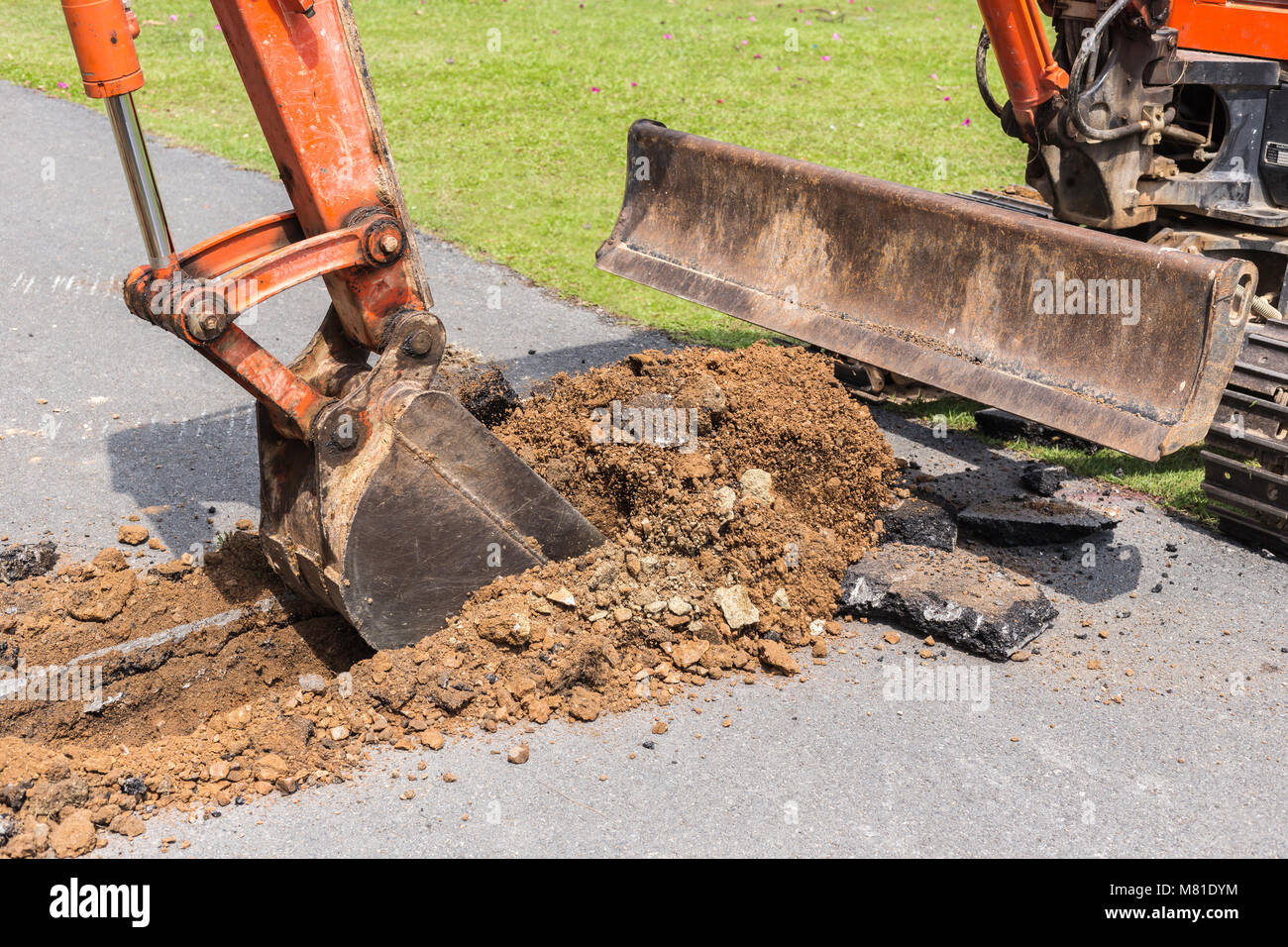 Excavator machine operate for digging soil and repair road in the