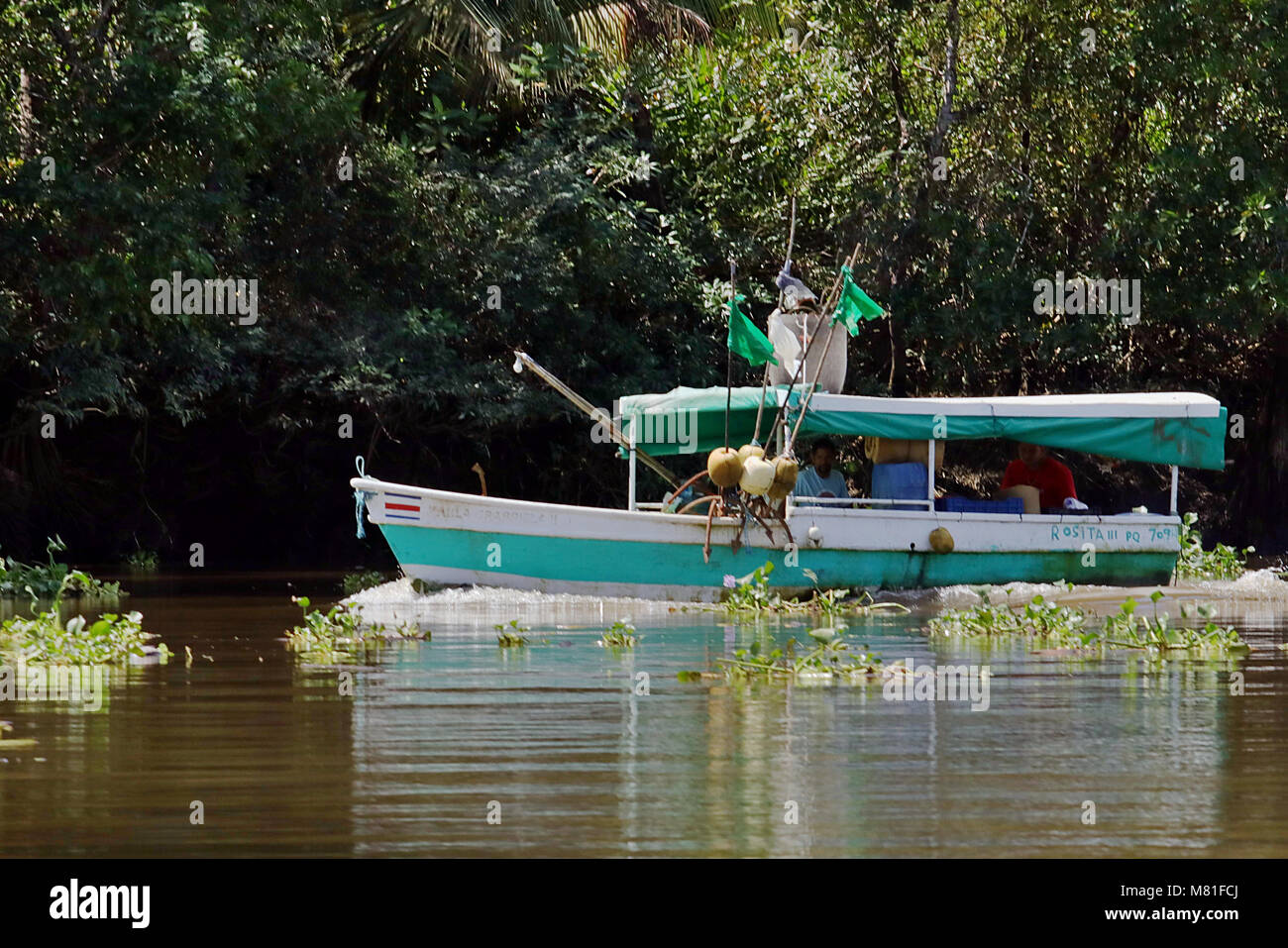 Small fishing boat traveling up the Rio Sierpe in Puntarenas Province, Costa Rica. Stock Photo
