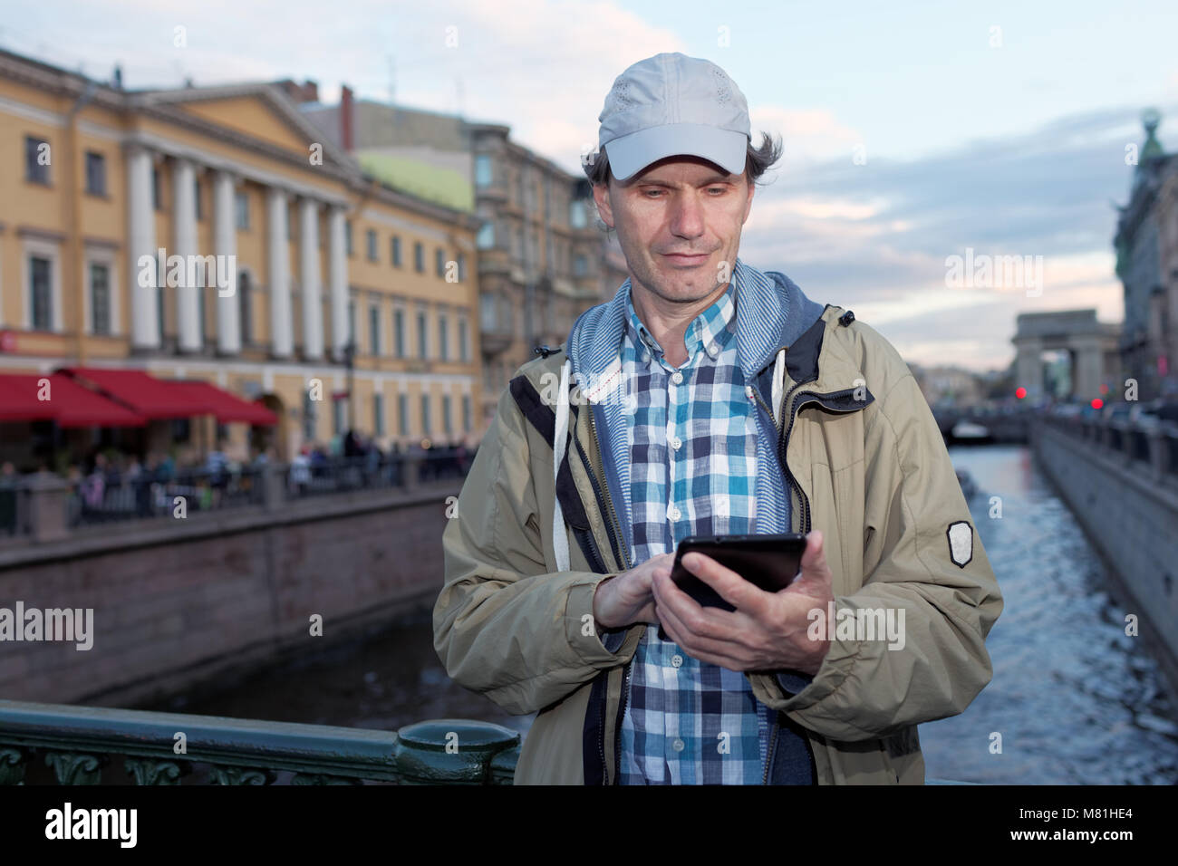 Mature tourist with a tablet in St. Petersburg, Russia Stock Photo