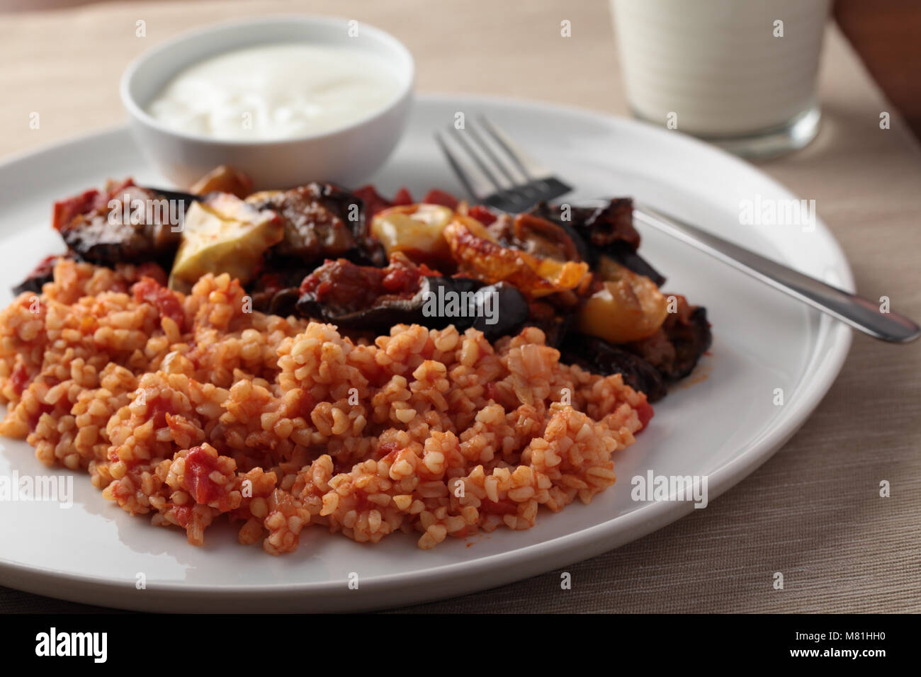 Bulgur pilaf on a plate with Greek yogurt Stock Photo Alamy