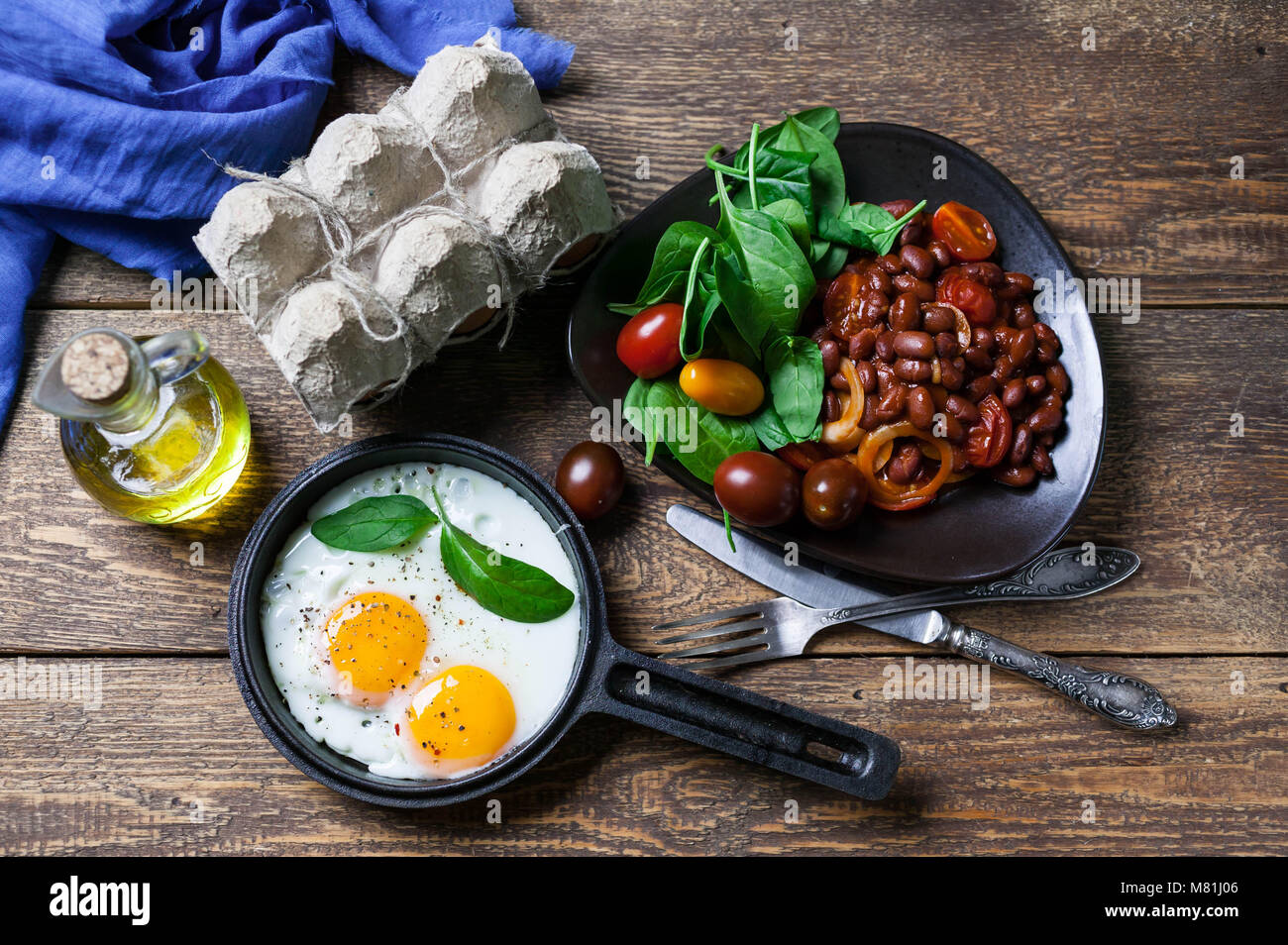 The pan fried eggs, haricot stewed in tomato sauce and fresh spinach