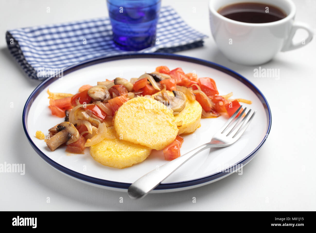 Polenta with roasted mushrooms, tomato, pepper, and onion Stock Photo