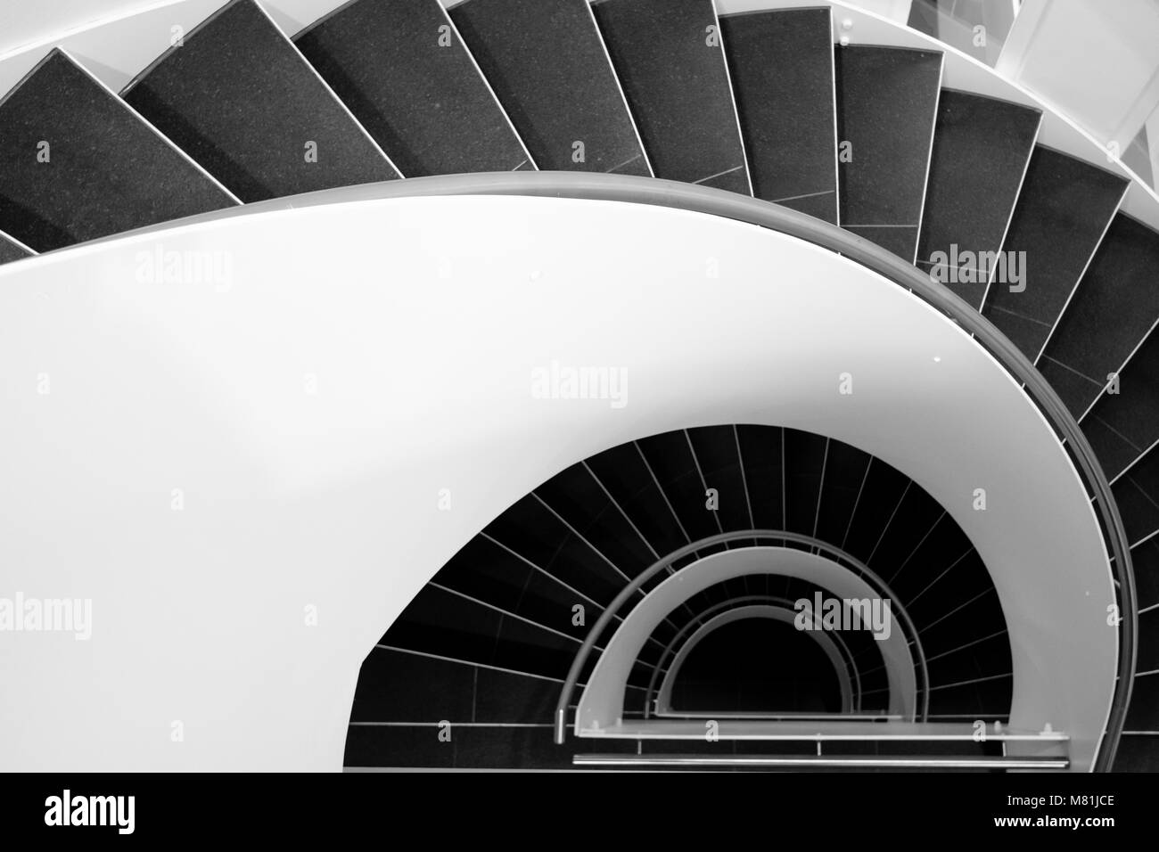 Spiral staircase in a modern building in black and white Stock Photo