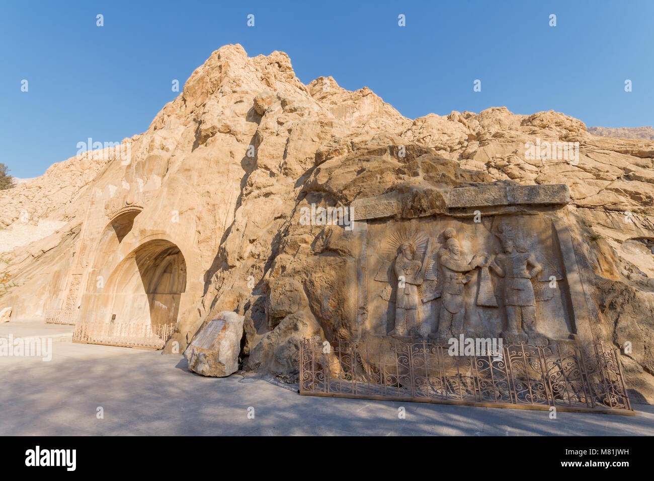 Taq-e Bostan. Kermanshah. Carved into rock, place with a several reliefs from era of Sassanid Empire of Persia. Winter season, shortly after sunrise. Stock Photo