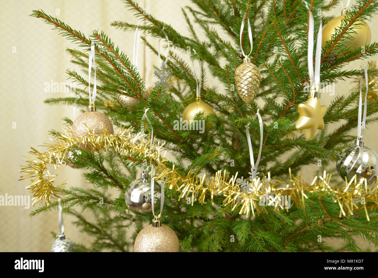 Decorated Christmas tree in golden colors Stock Photo - Alamy