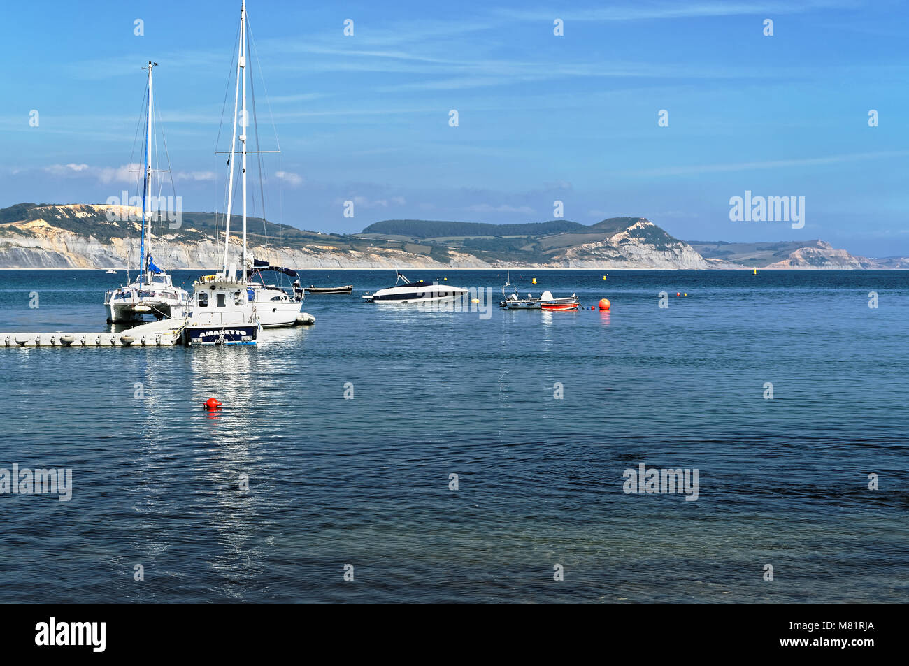 UK,Dorset,Lyme Regis,Boats and Jetty in Lyme Bay with Golden Cap and
