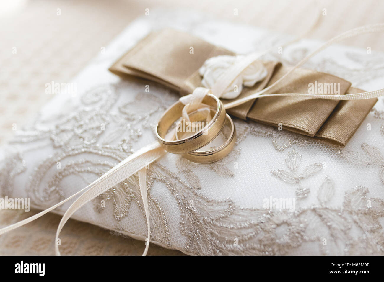 Golden wedding rings on pillow Stock Photo Alamy
