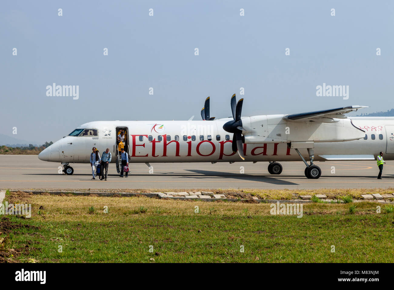 Passengers Getting Off An Ethiopian Airlines Airplane At Jinka Airport, Omo Valley, Ethiopia Stock Photo