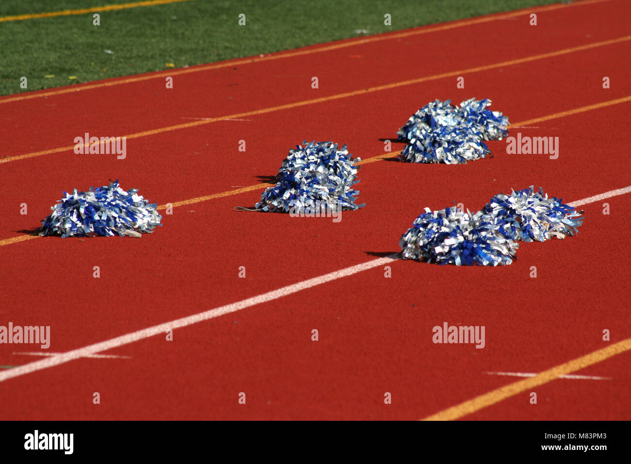 Cheerleader pom poms near a football field Stock Photo Alamy