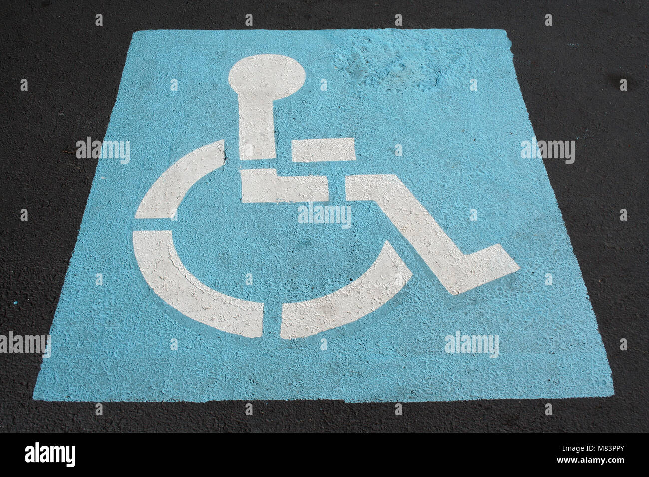 A Handicapped sign painted in a parking spot Stock Photo