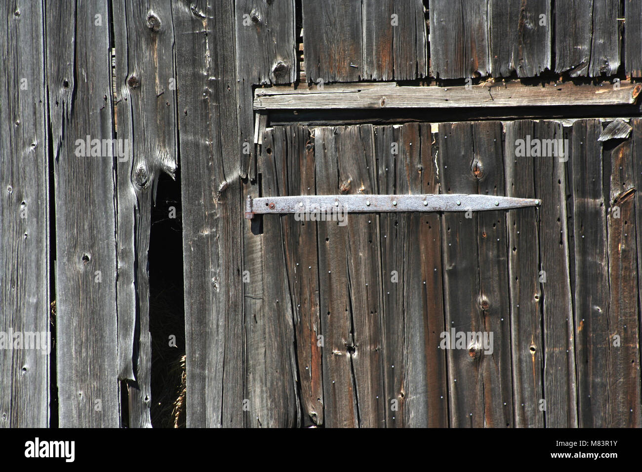 An Old wooden barn door and hinge Stock Photo