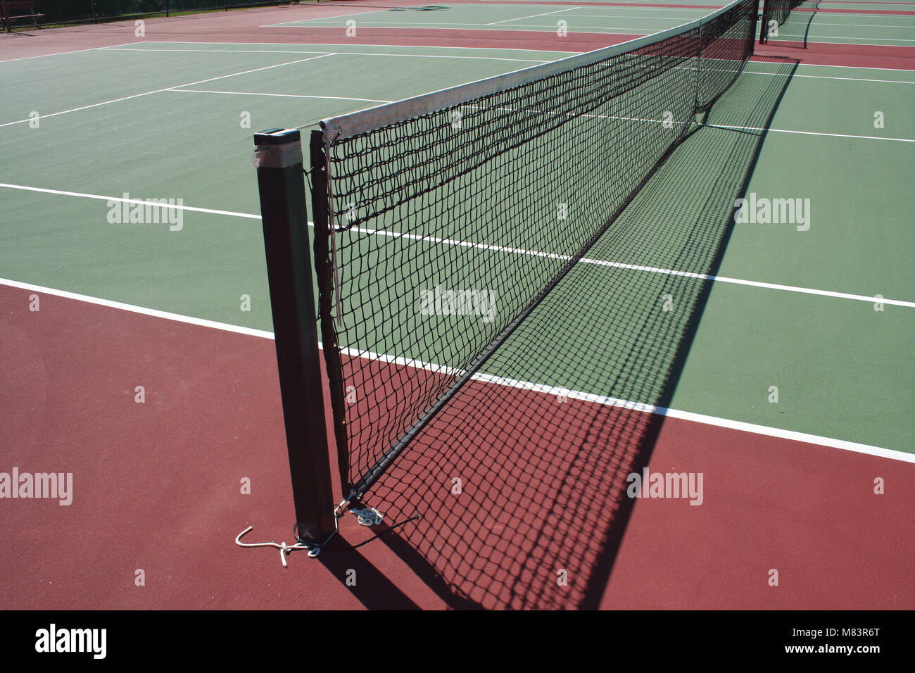 A empty green Tennis Court with net Stock Photo