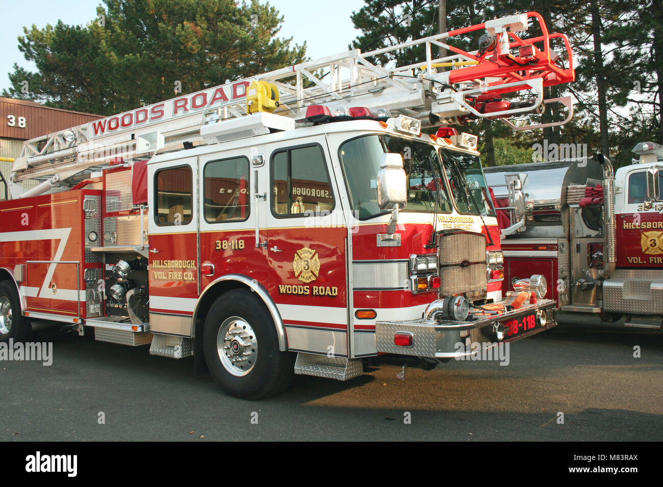 A Fire Truck parked outside a firehouse Stock Photo