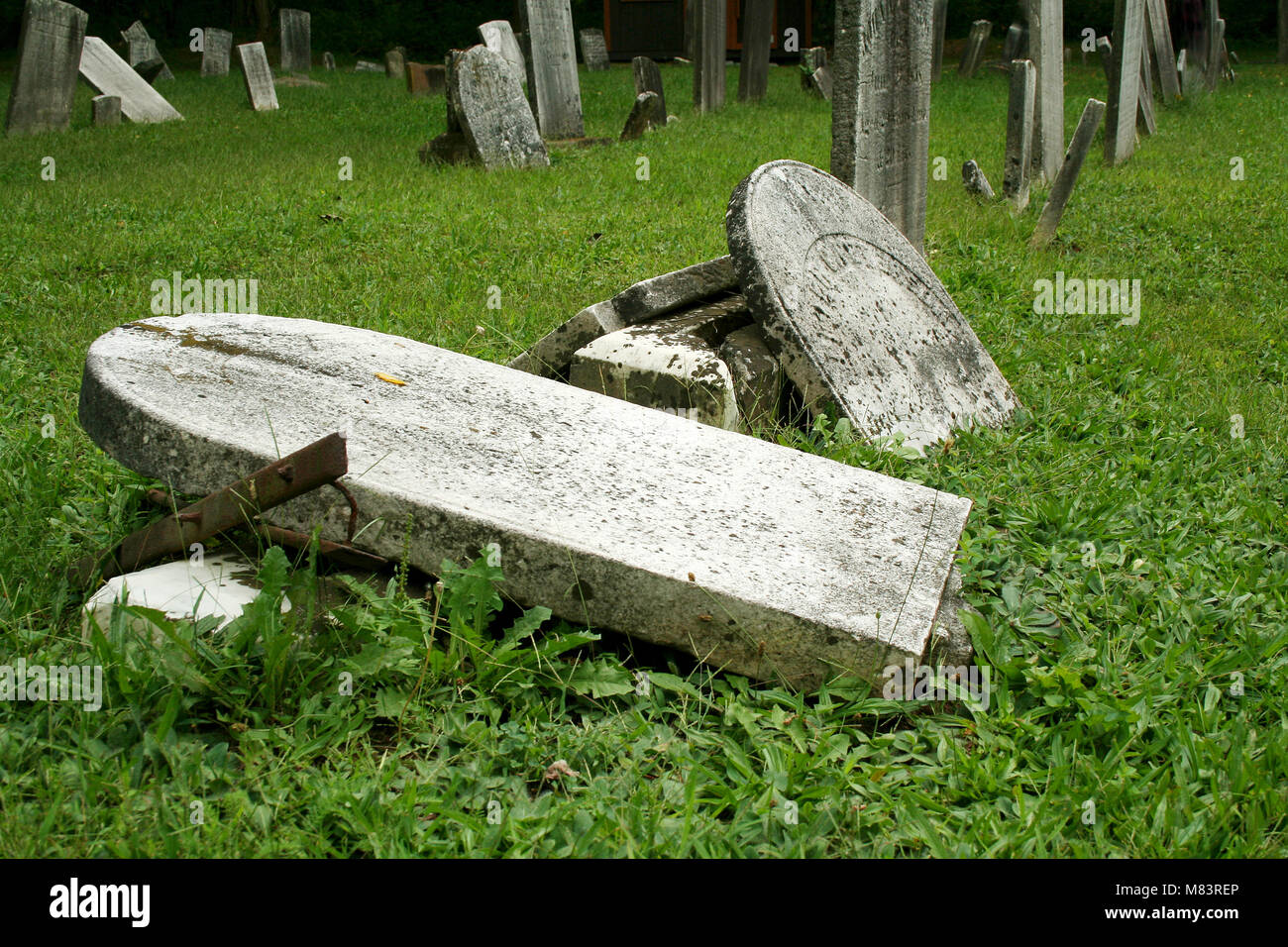 Broken Old Gravestones with grass in a graveyard Stock Photo - Alamy