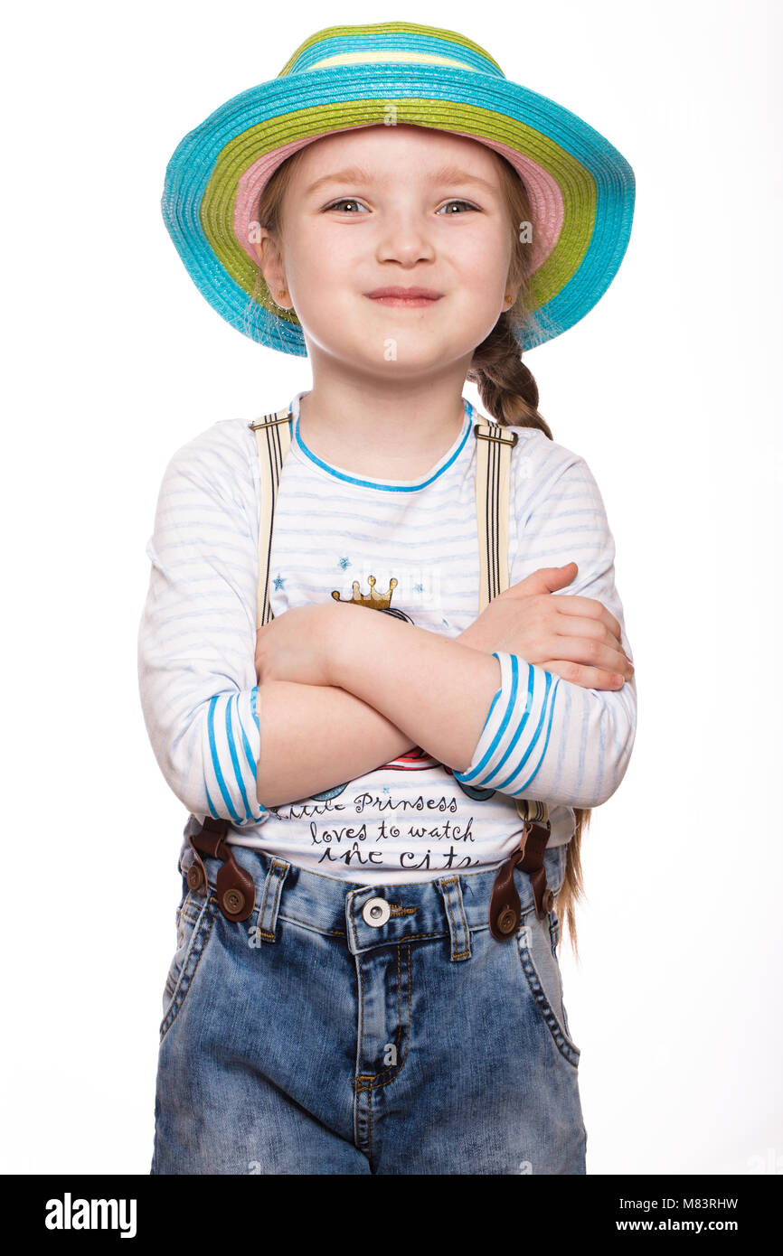 A little girl in a summer Panama, denim overalls Stock Photo Alamy