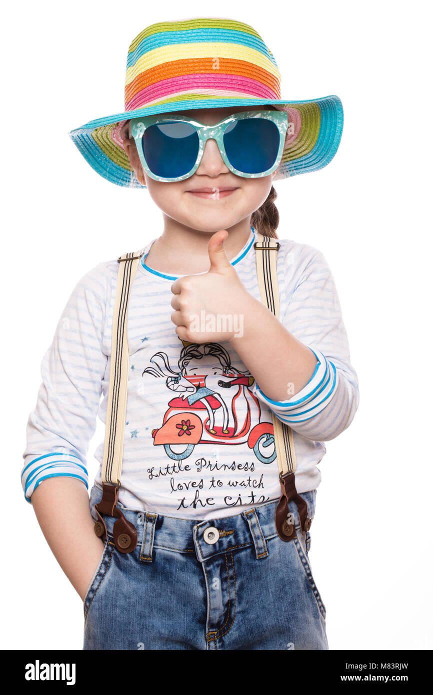 A little girl in a summer panama, denim overalls and sunglasses Stock ...