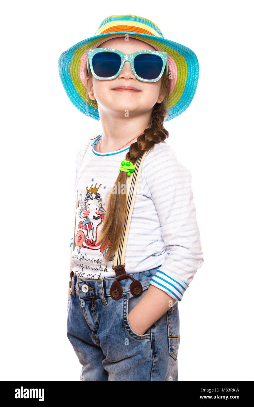 A little girl in a summer panama, denim overalls and sunglasses Stock ...