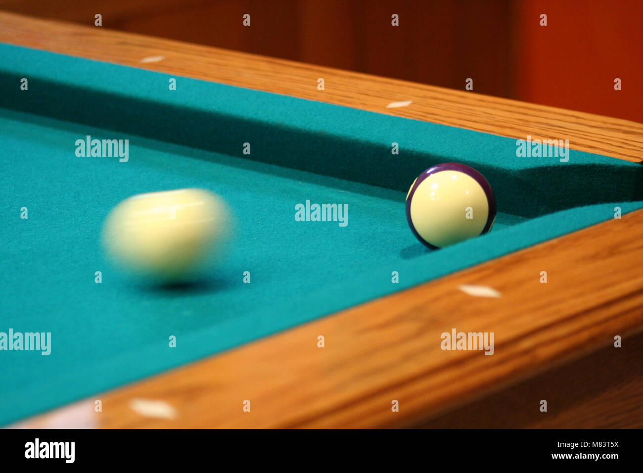 Cue ball in motion on a green pool table Stock Photo Alamy